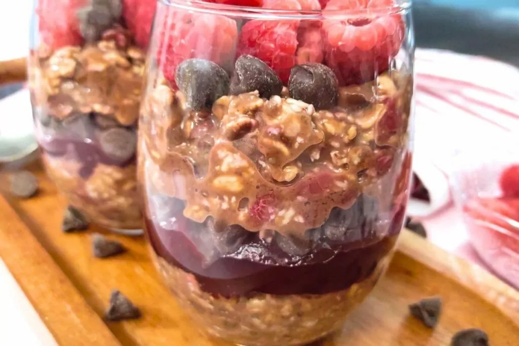 seeing the layers in a glass filled with raspberry chocolate overnight oats