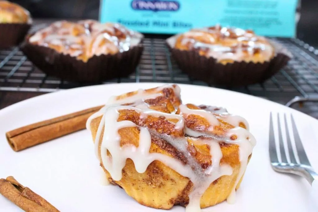 air fryer cinnabon mini bite on a plate with two more in the background