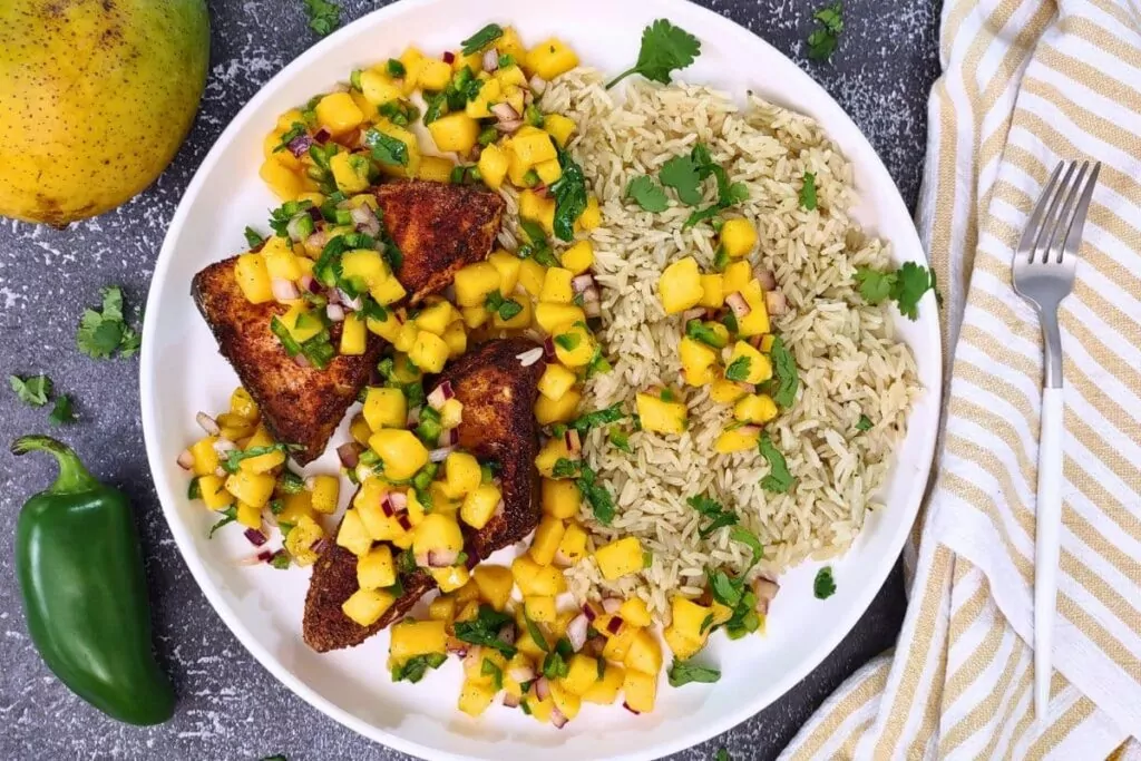overhead view of air fryer swordfish steak with mango salsa