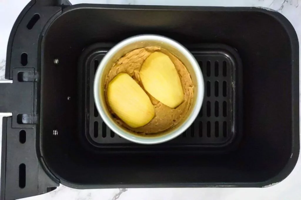 place filled apple cake pans in air fryer basket