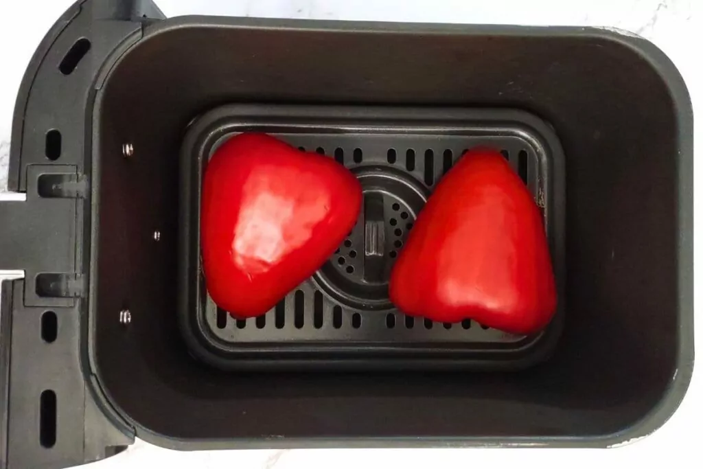 place red bell peppers in air fryer basket with the skin side up
