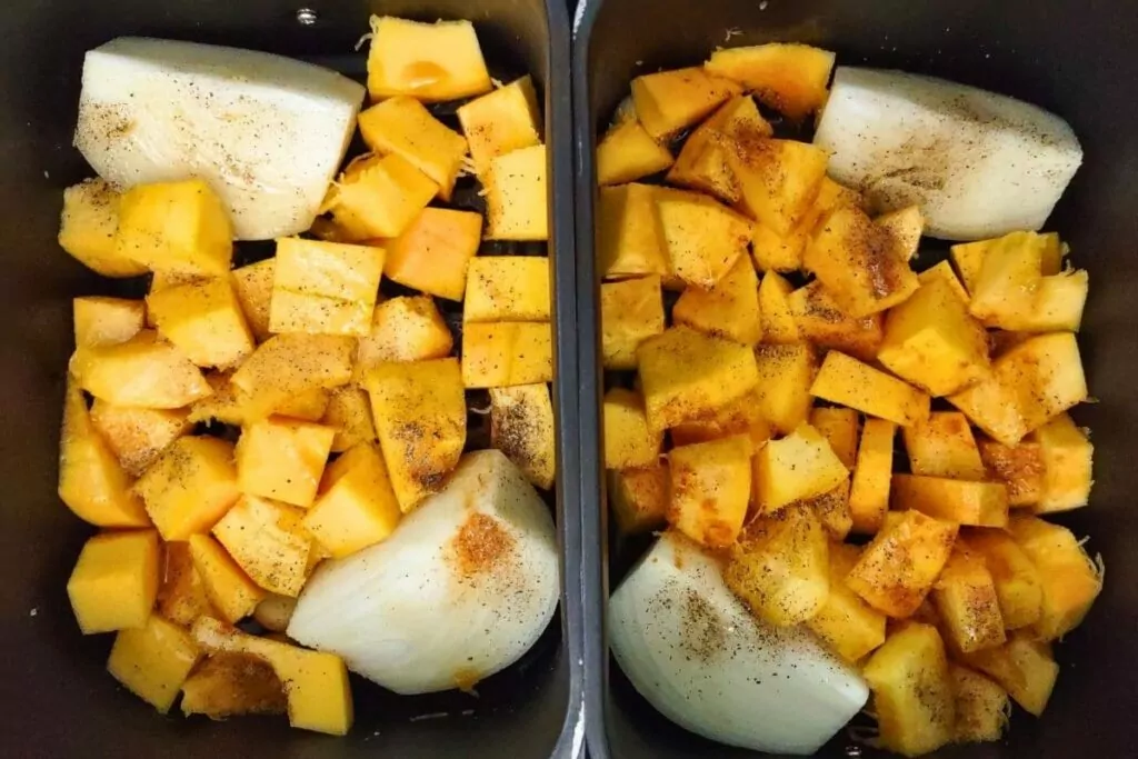 add cubes of seasoned pumpkin to air fryer basket
