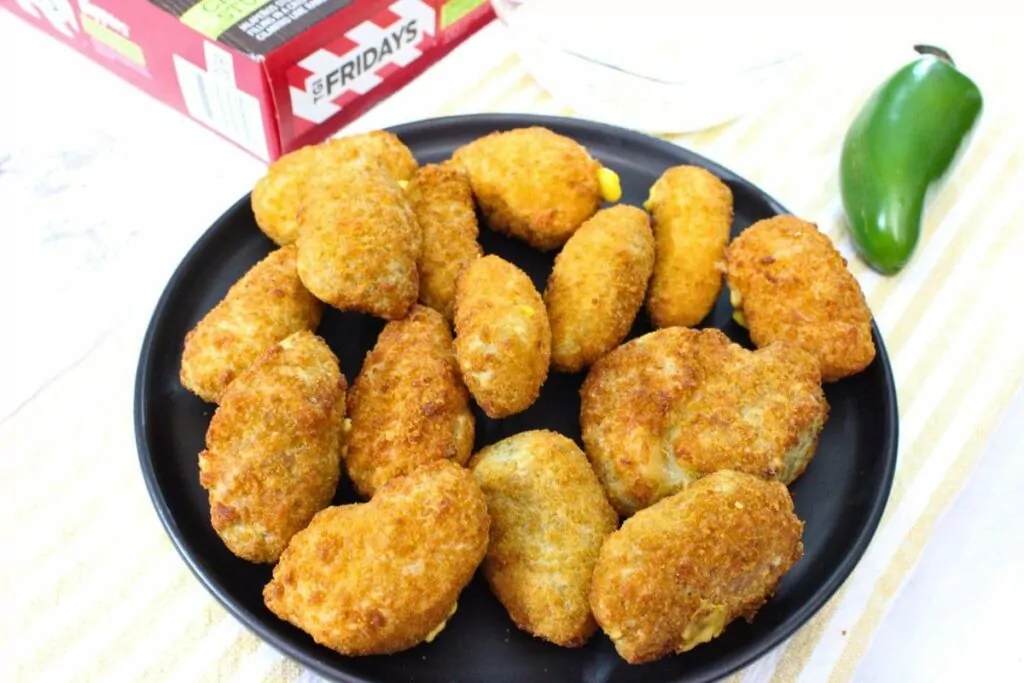 air fryer tgi fridays jalapeno poppers stacked up on a black plate