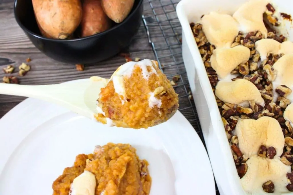 air fryer sweet potato casserole with marshmallow on a wooden spoon