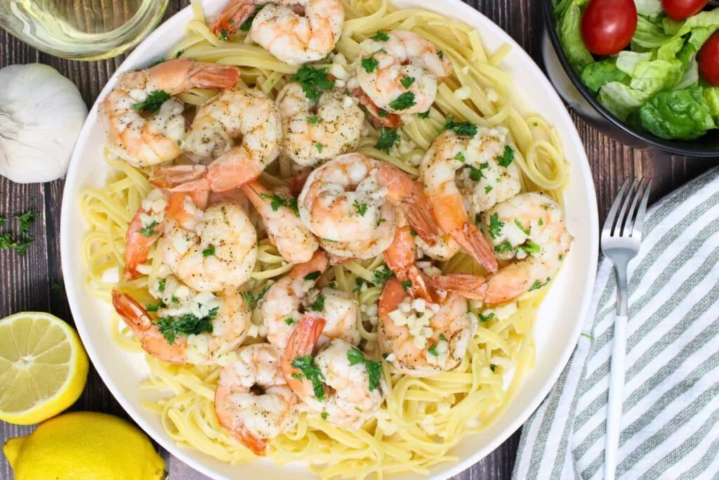 overhead view of air fryer shrimp scampi on a plate over noodles