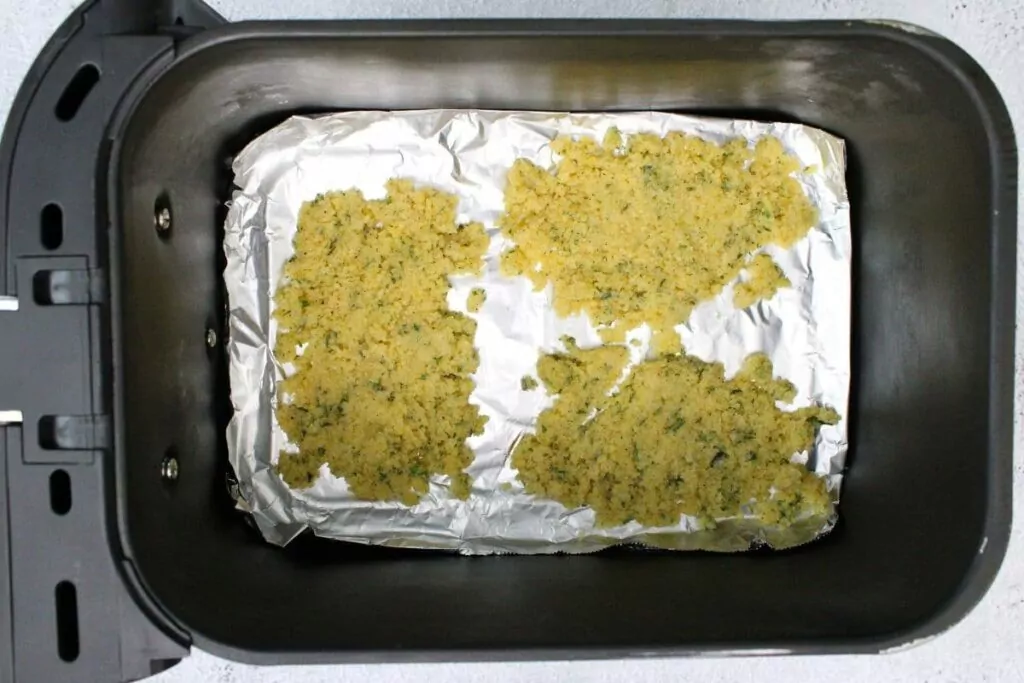 spread parmesan mixture on foil in air fryer basket