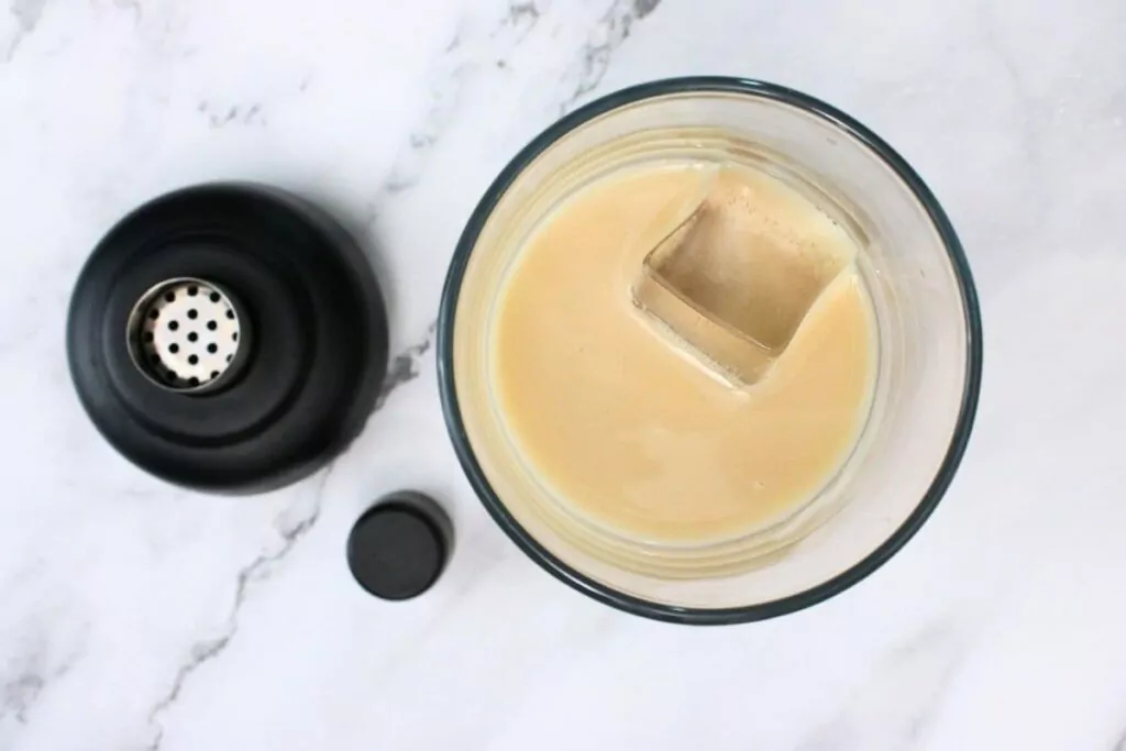 add coconut rum, vodka, amaretto, creme de cacao, and cream to a cocktail shaker