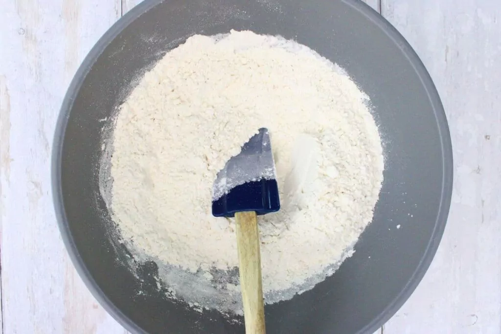 in a mixing bowl combine flour, baking powder, and salt