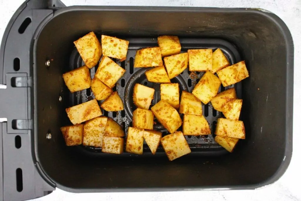 place seasoned potatoes in air fryer basket