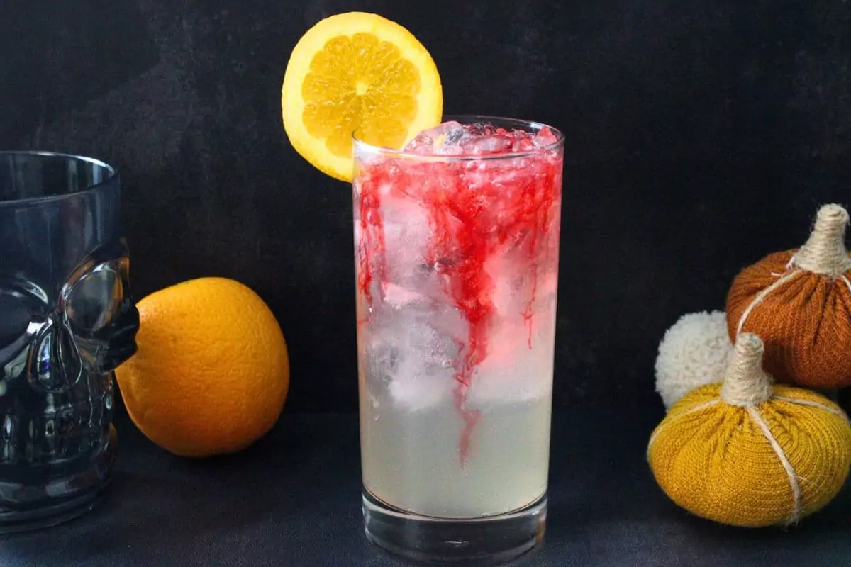 headless horseman cocktail with red liquid oozing down