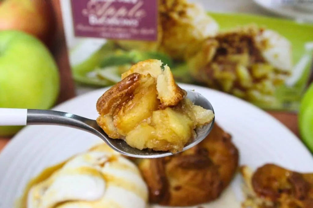 holding up a spoonful of trader joes air fryer apple blossom