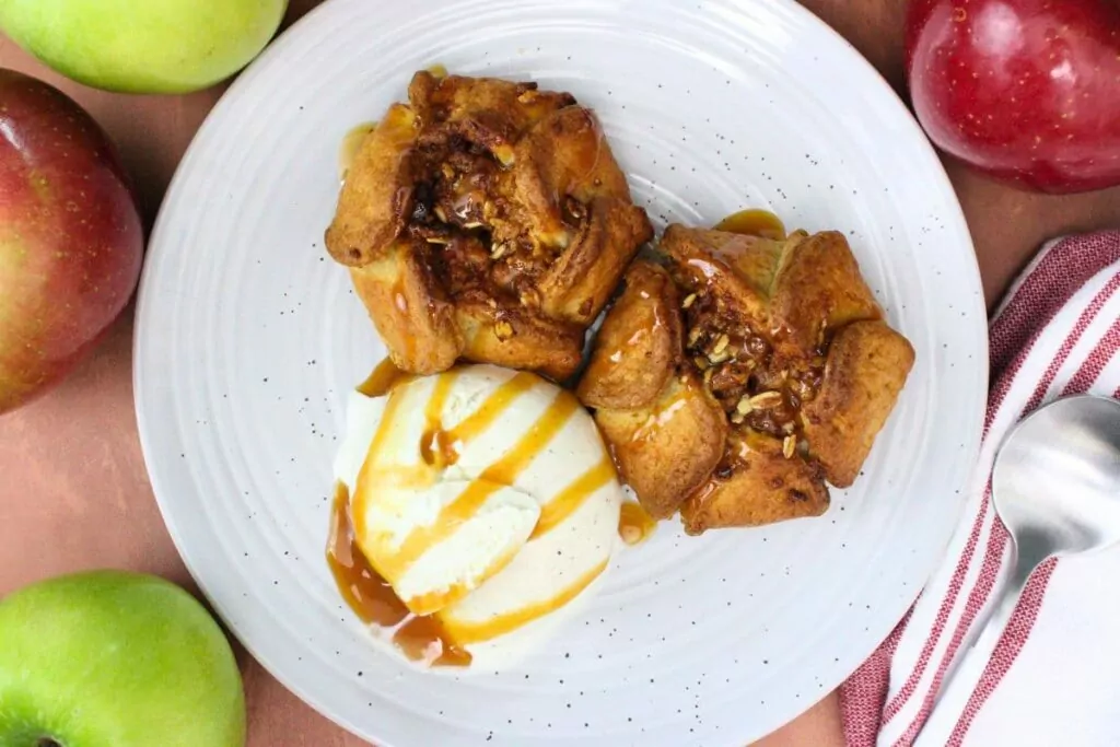 overhead view of two air fryer trader joes apple blossom on a plate with ice cream
