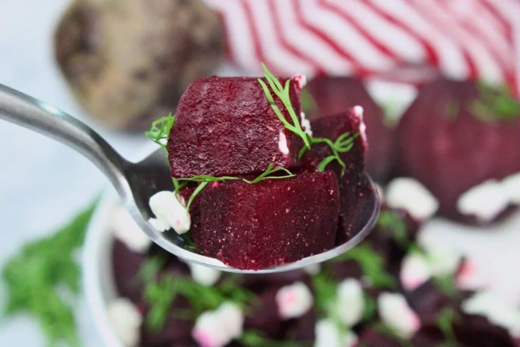 holding up a spoonful of fresh diced microwave beets