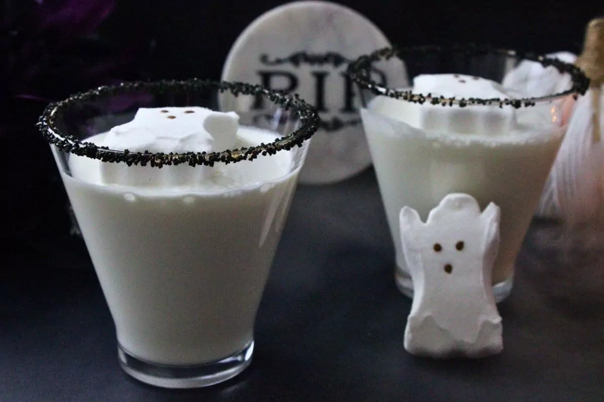 two ghost martini cocktails with black sugar rim