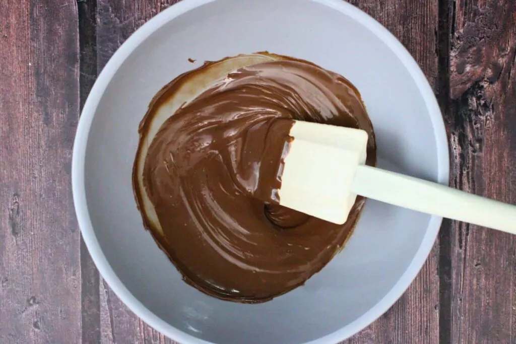 add milk chocolate chips to microwave safe bowl and heat until melted