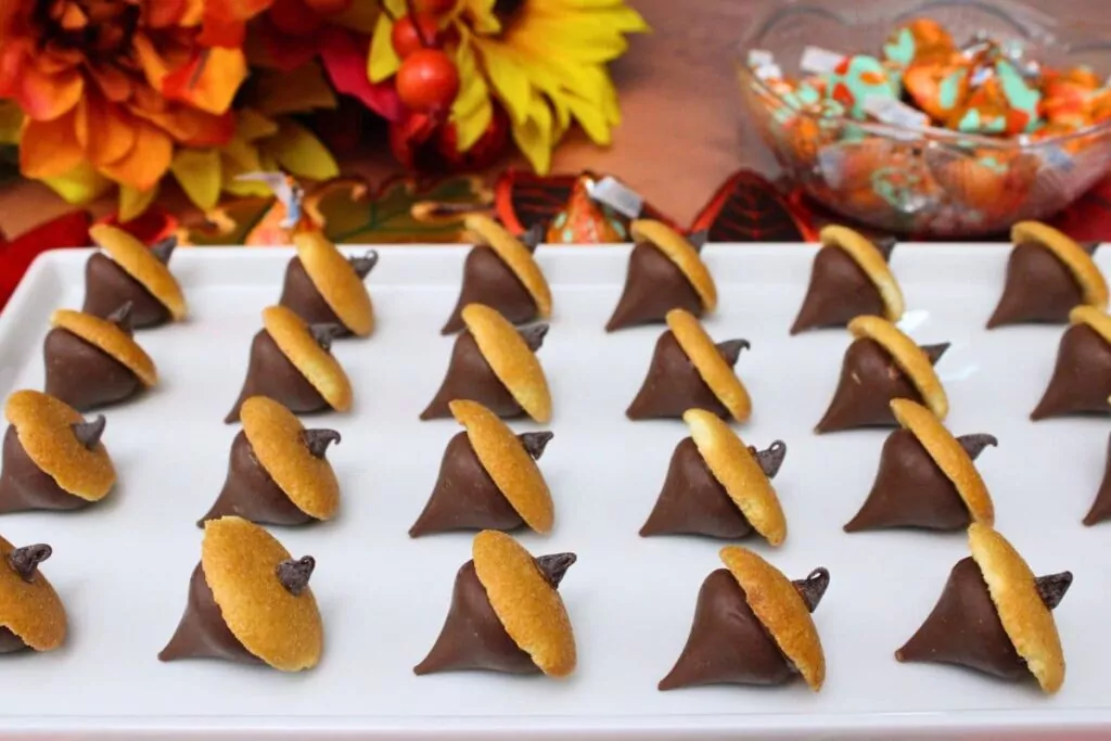 hershey kiss acorns on a plate against a fall background