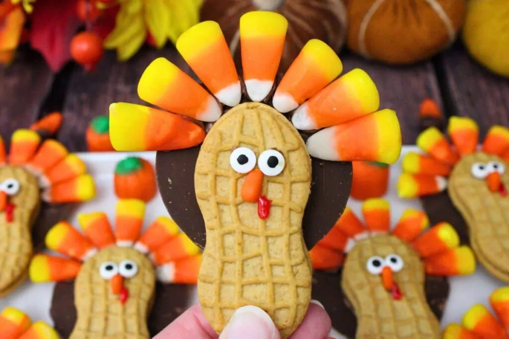 holding up a nutter butter turkey cookie close to the camera