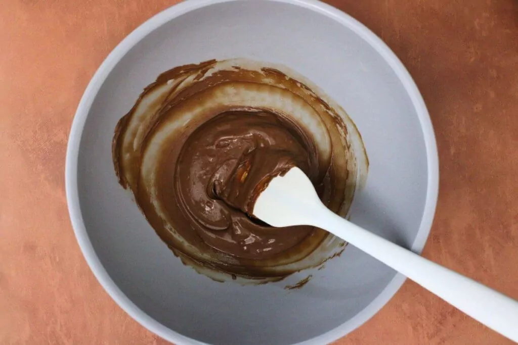 in a small microwave bowl melt a quarter of the chocolate chips