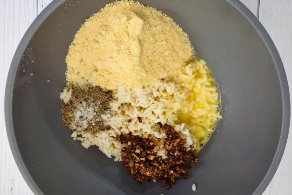add rice, eggs, parmesan cheese, seasoning, and butter mixture to a bowl