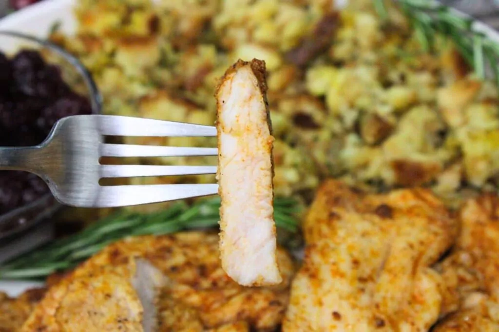 holding up a fork with a piece of air fryer turkey