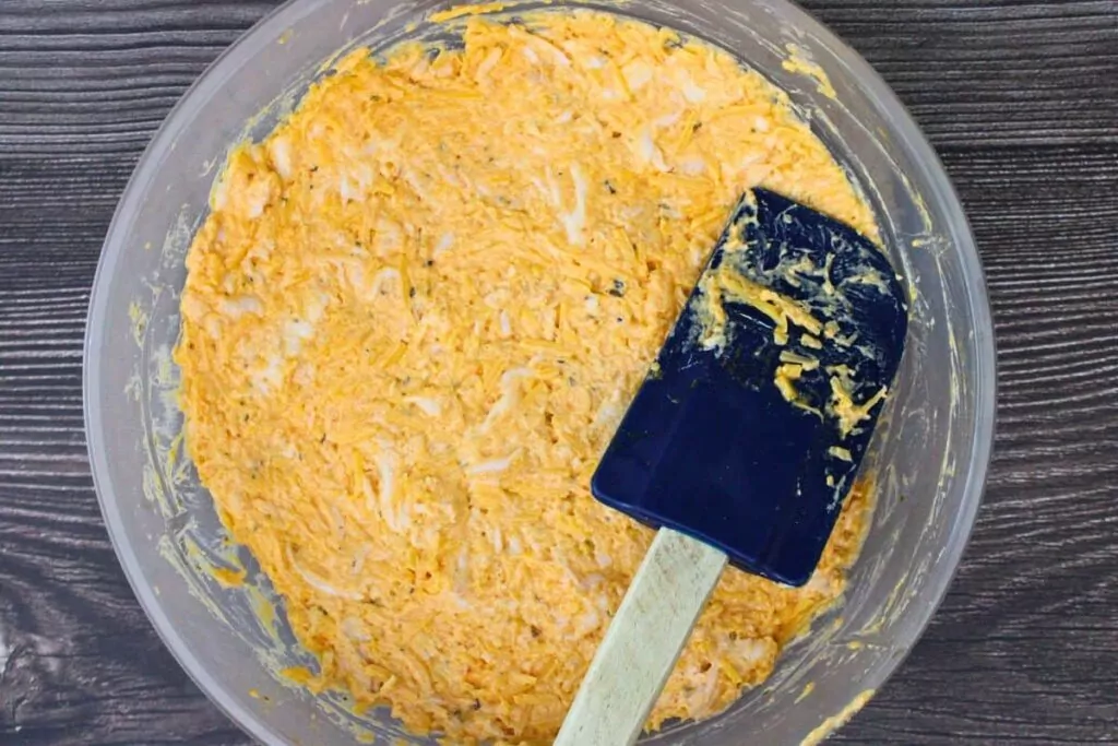 mix chicken cream cheese, wing sauce, ranch seasoning, sriracha, and cheddar cheese in a microwave safe dish
