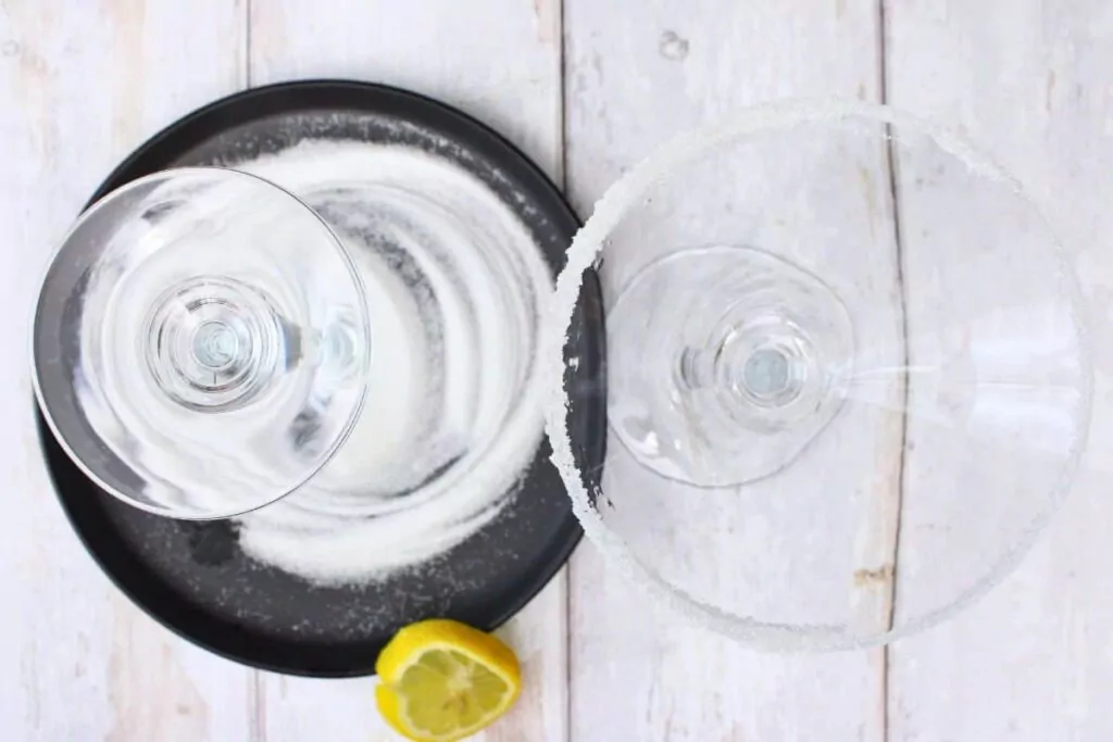 rim pink lemon drop glass with lemon and sugar