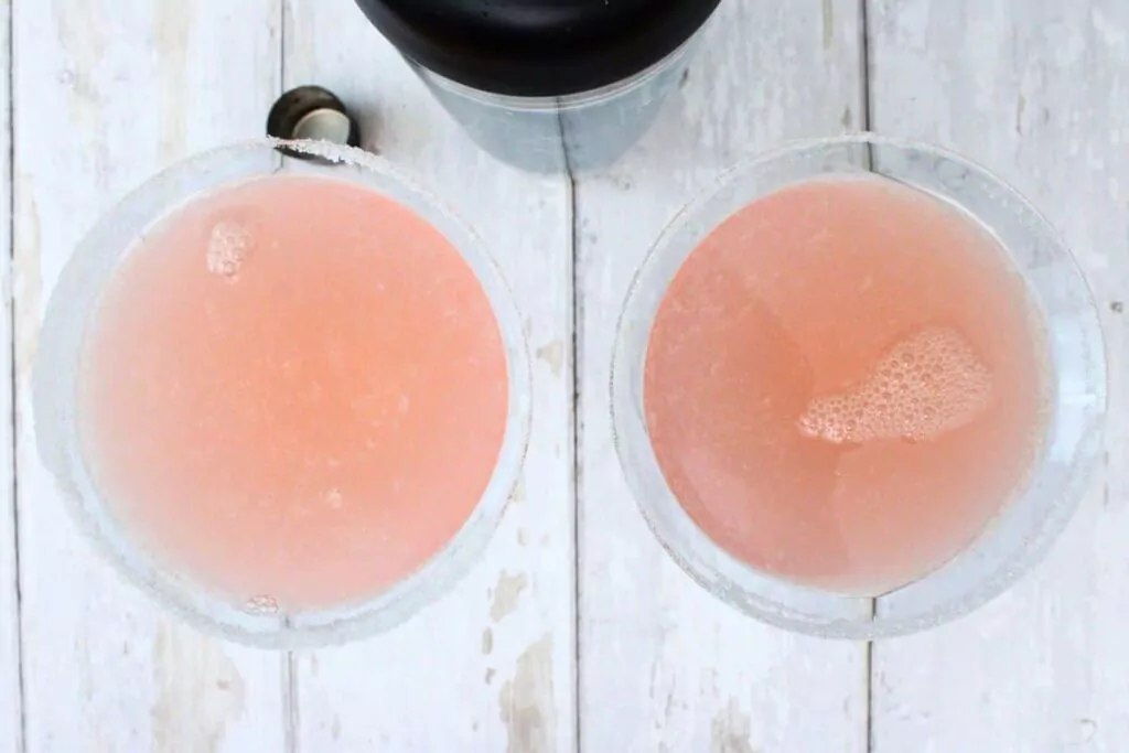 shake and strain chilled pink lemon drop into prepared martini glasses