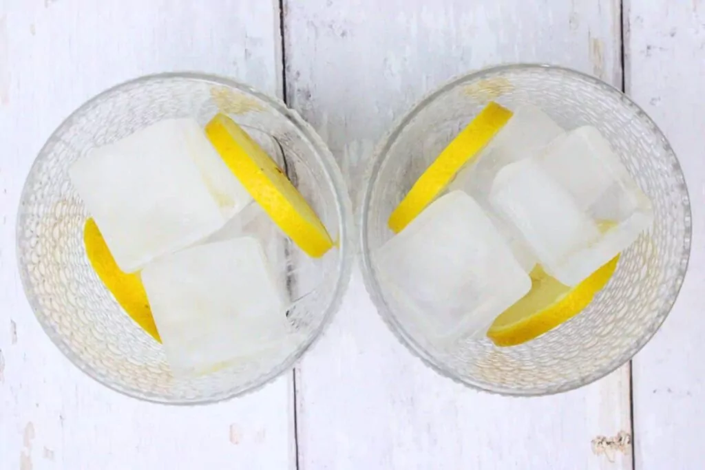 add fresh fruit and ice to glasses