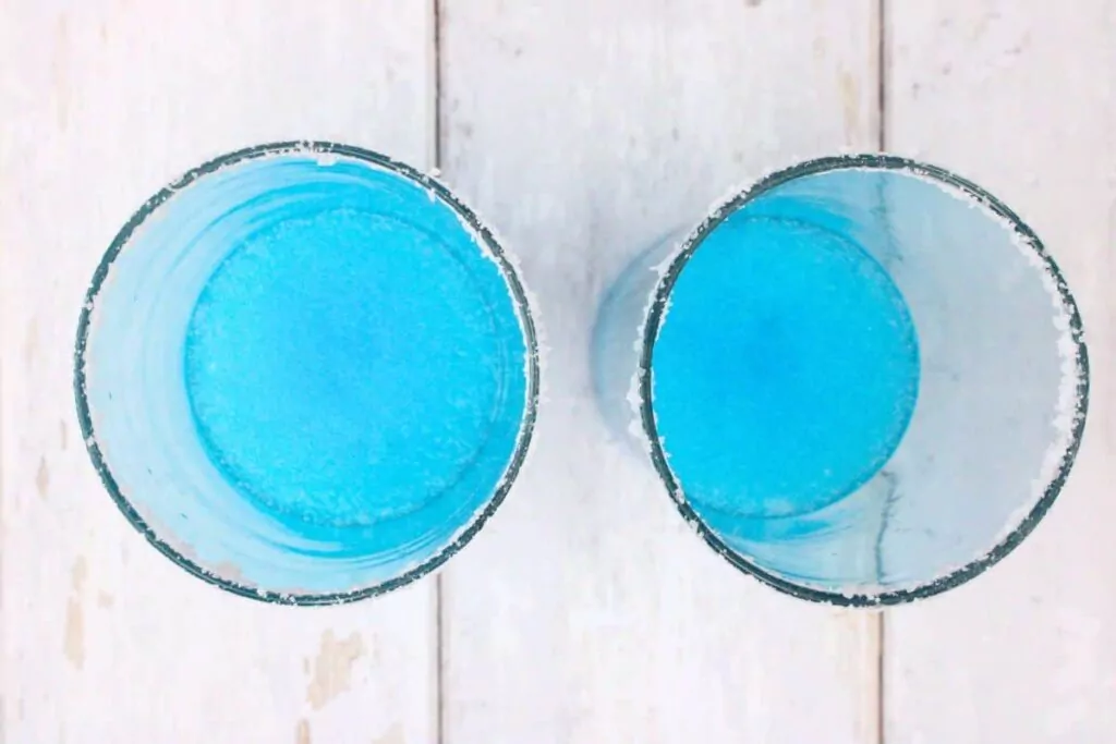pour the blue slushie mixture into the bottom of the glass