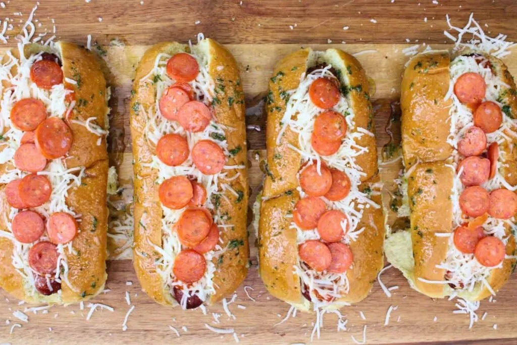 brush edges of pizza hot dog buns with garlic butter
