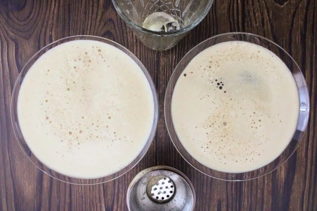 shake and strain frothy chocolate espresso martini into glasses