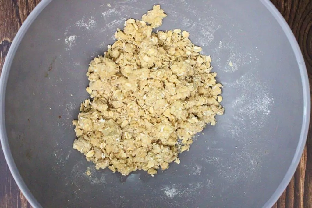 combine oats with flour, brown sugar, and cubed butter in a bowl