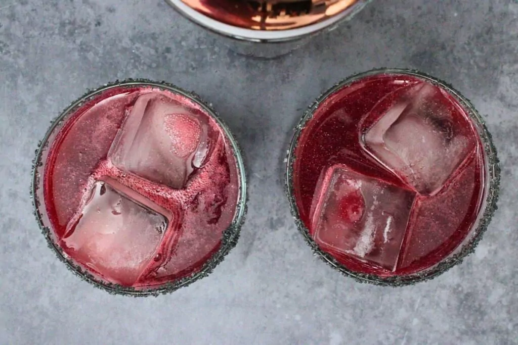 shake and strain black magic margaritas into prepared glasses