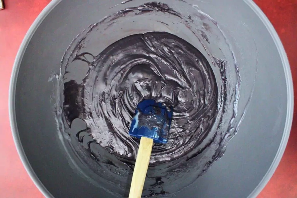 add black candy melts and sweetened condensed milk to second bowl and microwave