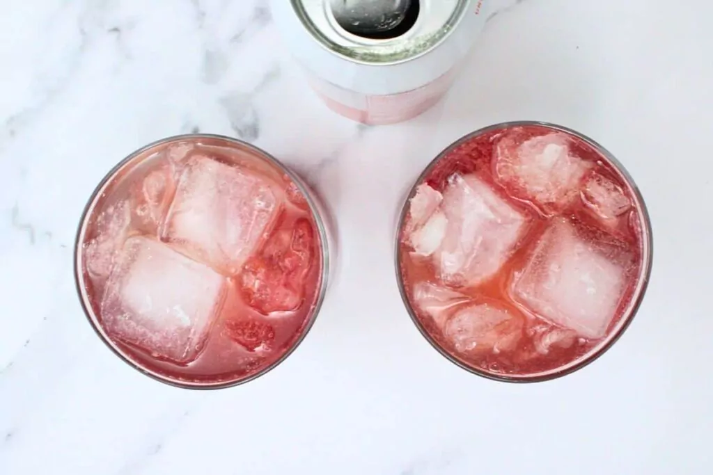 pour sparkling water over blood orange and gin mixture