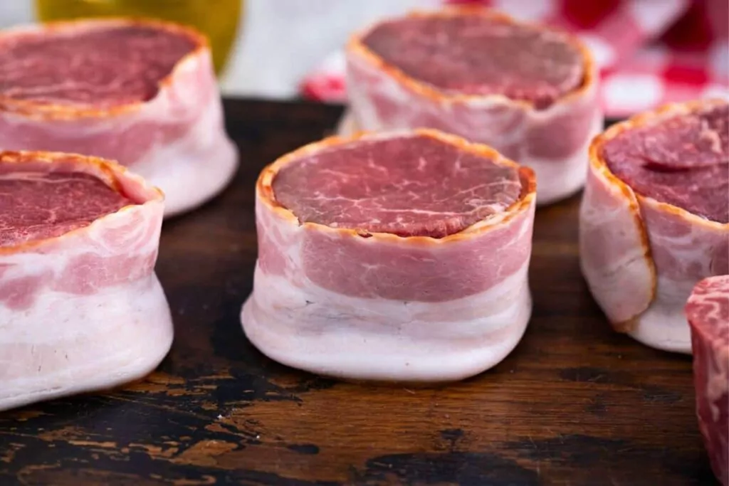 wrap each filet with a strip of bacon
