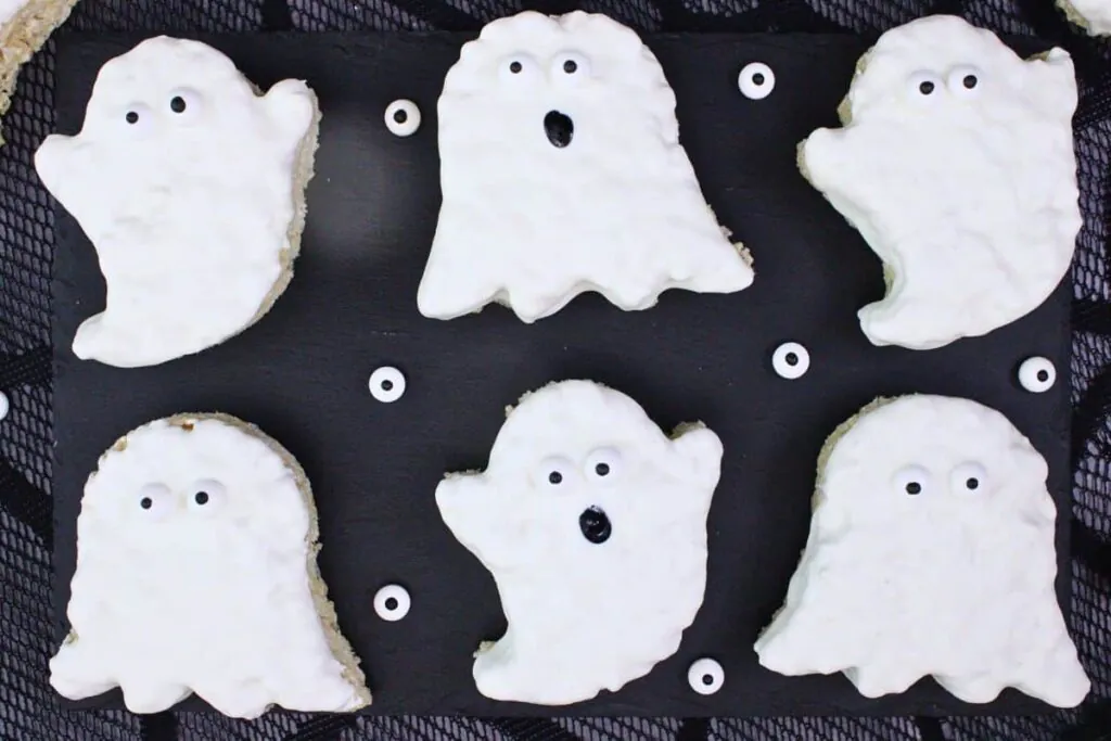 overhead view of several different ghost rice krispie treats on black slate